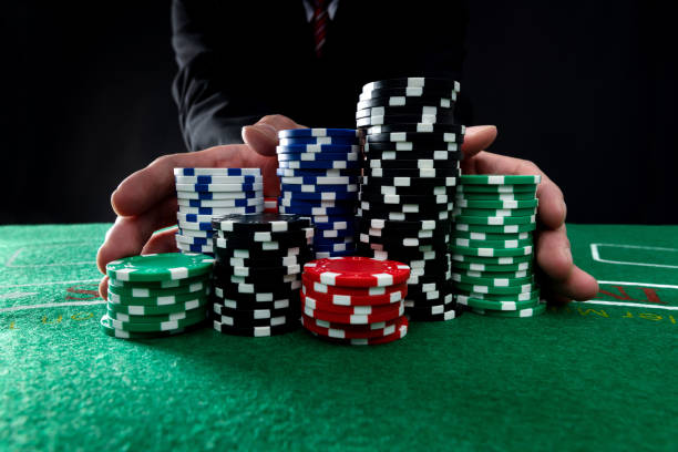 Businessman hands pushing gambling chips.